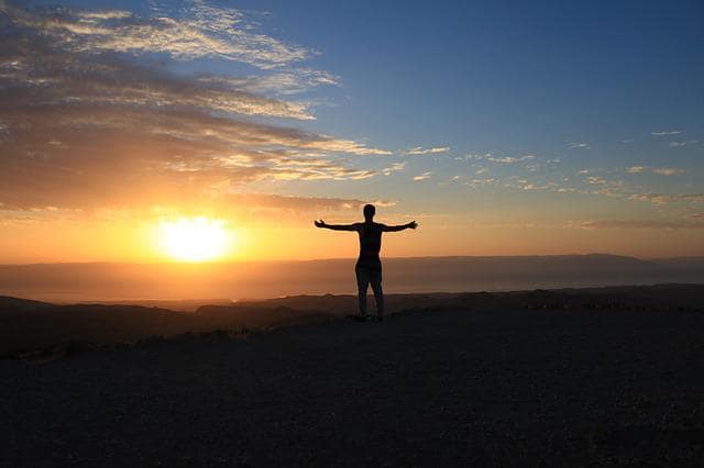 Man with open arms repeating positive affirmations